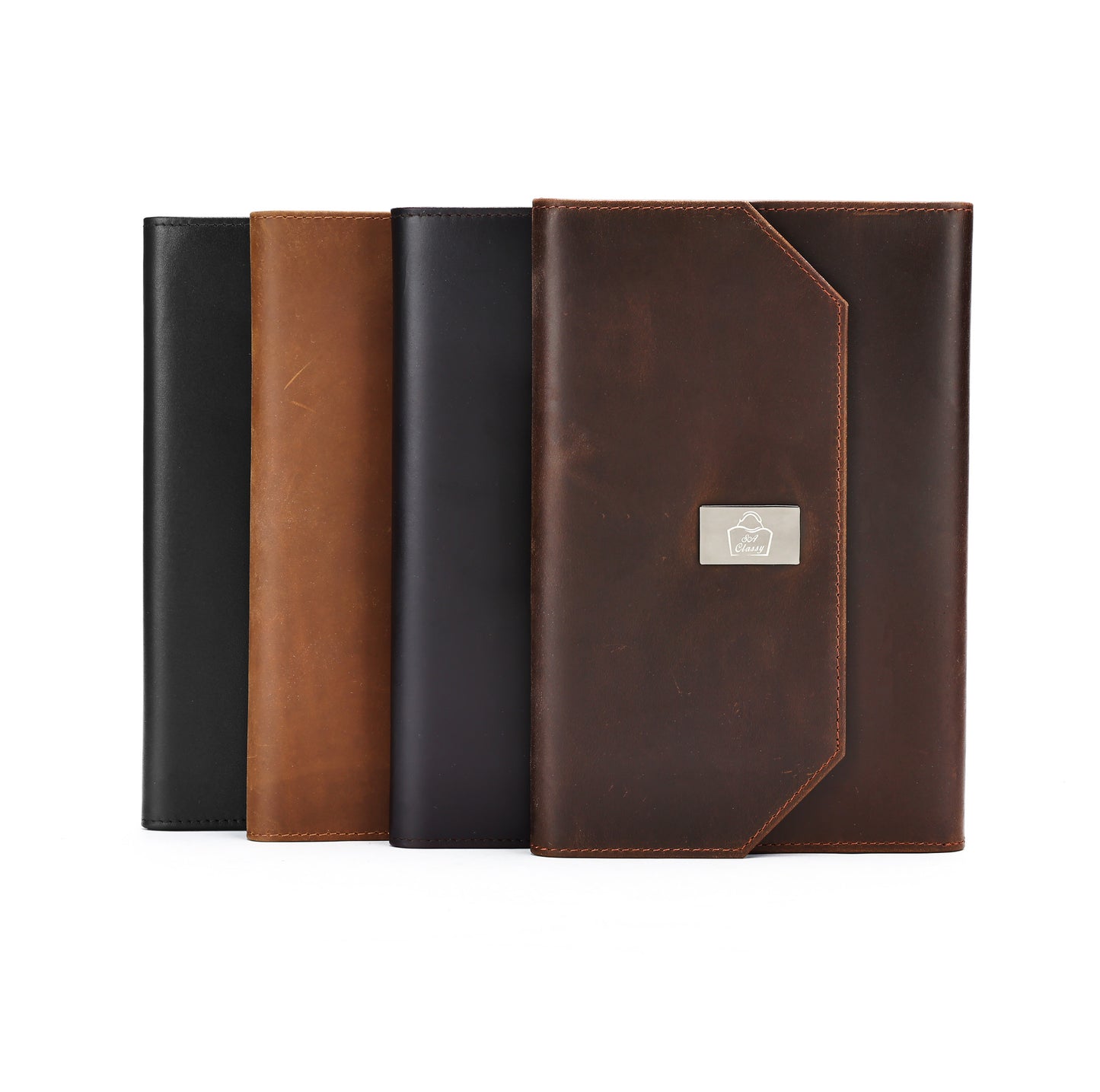 Four leather-bound books in black, brown, and a combination of both on a white background.